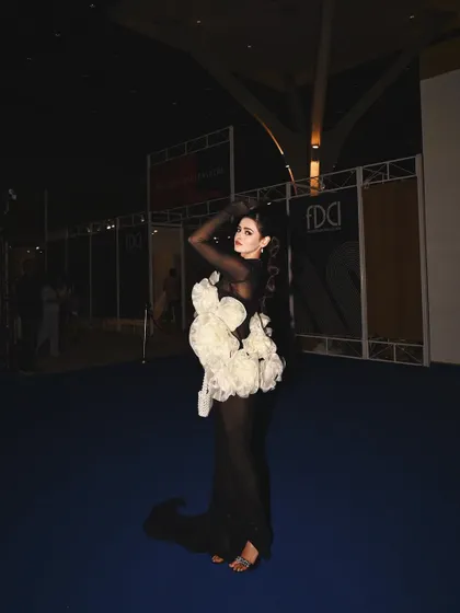 A full-length shot capturing the artistry of a major fashion event. The beauty look I designed was meant to complement the dramatic silhouette of the gown, creating a memorable image.