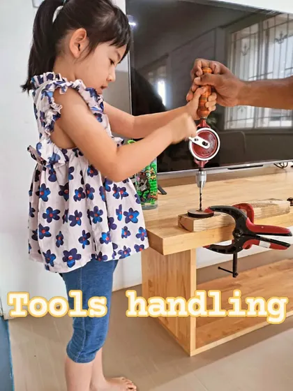 With a little help, a student learns the proper technique for using a hand drill. Our instructors ensure every child is supported as they learn new skills.
