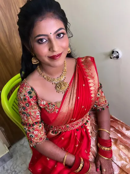 My bride Chaithra looking stunning for her engagement. We went for a classic look with bold red lips and defined eyes to match her red and gold half-saree.