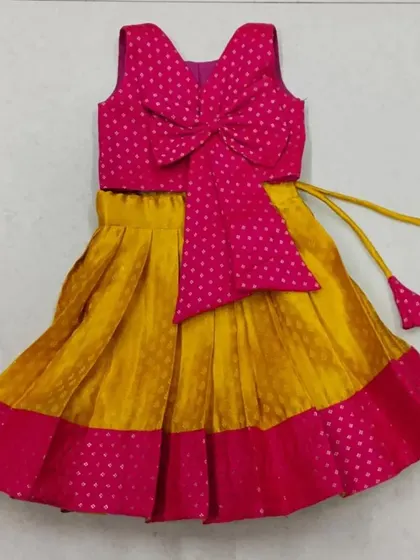 This is a cute and modern langa blouse design. I used a bright pink and yellow combination and added a large bow for a playful touch.