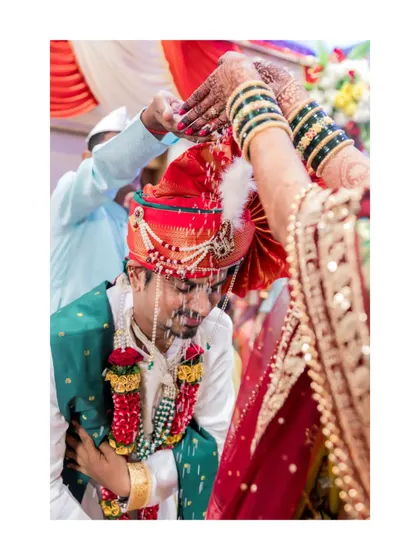 The groom receives blessings during the wedding rituals, a moment of tradition and respect.