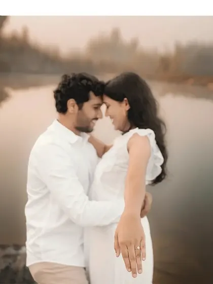 A close-up on the engagement ring, with the couple sharing an intimate moment by the misty lake in the background. This shot beautifully combines a key detail with a romantic scene.