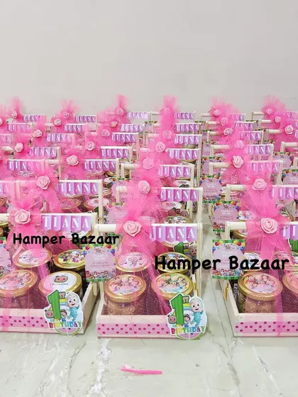 A bulk order of Cocomelon themed first birthday hampers for Tiana, all decked out in pink.