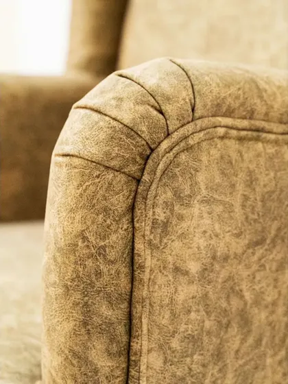 The armrest detail of the wingback chair, showcasing the quality of our upholstery work.