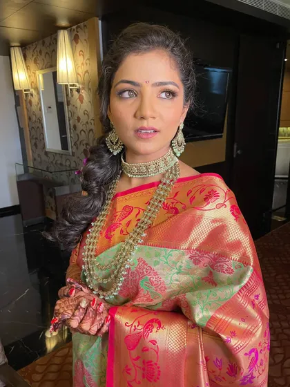 A candid moment of the bride looking thoughtful and serene. The makeup looks flawless from every angle.