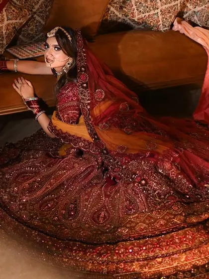 An artistic shot capturing the bride and the magnificent spread of her heavily embroidered lehenga.