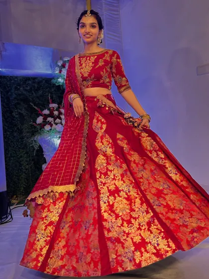 A vision of poise and grace. My client embodies elegance in this exquisite red suede lehenga, a vibrant and joyful choice for her wedding festivities.