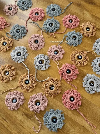 Preparing a large order of the mini evil eye wall hangings. Seeing them all together shows the beautiful color palette the client chose for her event.