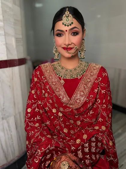 My beautiful bride Shweta for her Anand Karaj look. The bold red lip and defined eyes are a perfect match for her traditional and vibrant outfit.