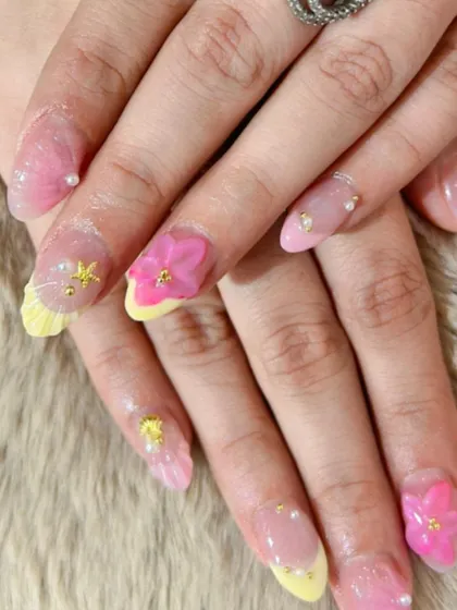 A playful, mermaid-inspired set with 3D flowers, starfish, and pearl details on a pink and yellow base.