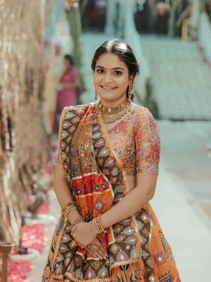 A portrait of the client, her hair styled elegantly for the traditional pooja.