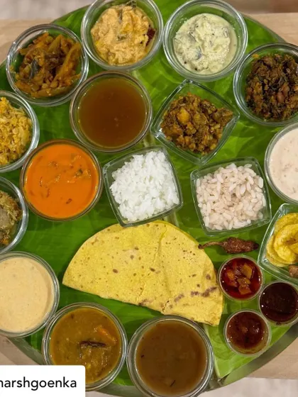 A top-down view of my Sadya, as shared by a happy client. This spread features over 20 distinct items, including multiple curries, thorans, pachadi, pickles, chips, and two types of rice, offering a complete journey through Kerala's vegetarian cuisine.