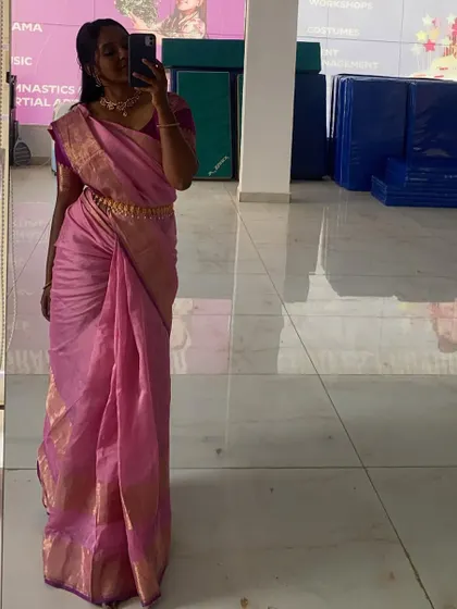 A mirror selfie showing off the full saree drape. I can teach you how to move gracefully and confidently in a saree for your performance.
