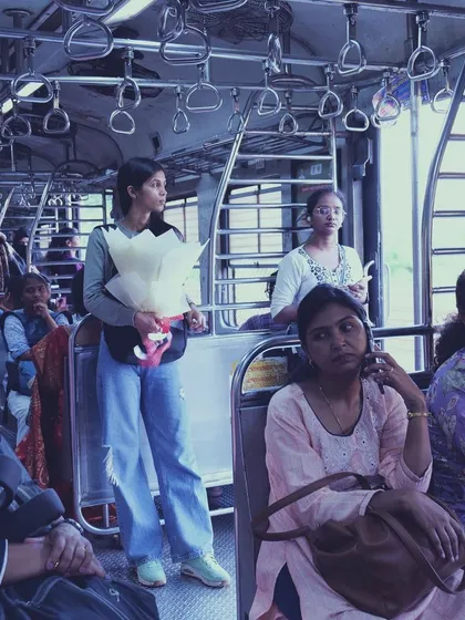 A wider view of the women's compartment in a Mumbai local. It shows the diverse faces and stories of women traveling together, each in their own world.