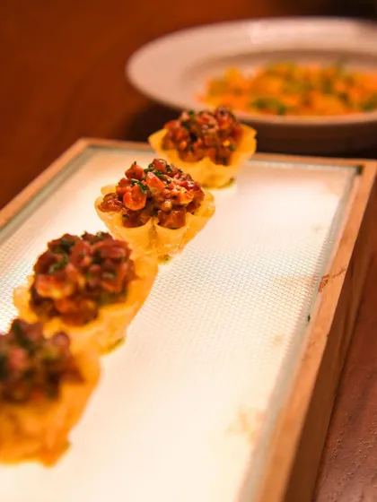 Our Steak Tartare served in delicate, crunchy tart shells. This play on textures elevates the classic dish, adding a new dimension to the rich, meaty flavour.
