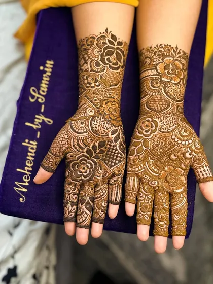 A close-up of the palms, showing the beautiful floral mandala and the intricate details on the fingers.