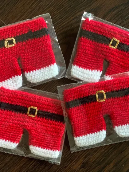 A set of Santa pants cutlery holders, packed and ready to go to a client.