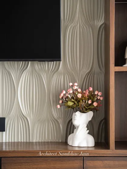 A perfect interplay of form and finish. The rich PU paneling adds a refined sheen, while the 3D textured wall brings depth and dimension. Accented with warm wood tones and curated decor, this setup balances minimalism with character.