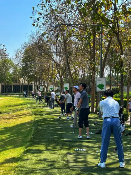 A packed driving range on a sunny day. Our facility can easily accommodate large groups for corporate events or private parties.