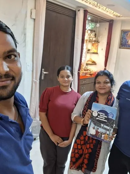 A family receives their solar information packet from our team member in their living room. We make the process comfortable and convenient.