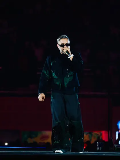 A clean, powerful shot of Yo Yo Honey Singh on a dark stage. This minimalist composition puts all the focus on the artist.