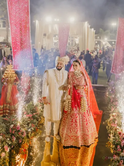 The couple's grand entry down a mirrored aisle, flanked by sparklers, creating a magical start to their ceremony.
