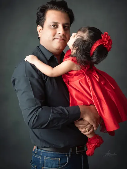 A father's gentle kiss for his daughter. These are the moments that truly matter.
