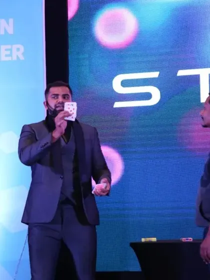 Performing a classic card illusion for a volunteer from Stellantis. Even in a large-scale show, these one-on-one interactions create powerful, personal moments of magic.