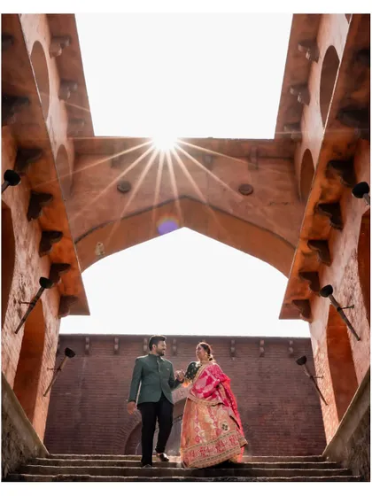 A powerful silhouette of the couple against the sun during their pre-wedding shoot at a historic location, showcasing my use of creative lighting and angles.