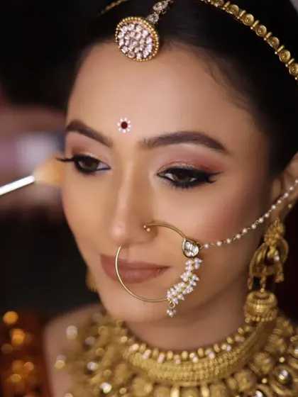 A beautiful Rajasthani-inspired bridal look. The makeup is kept minimal and elegant to complement the traditional jewelry and attire, focusing on flawless skin and softly defined features.