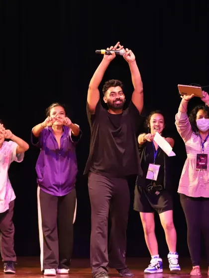 The team that makes it all happen. A behind-the-scenes moment of celebration on stage.