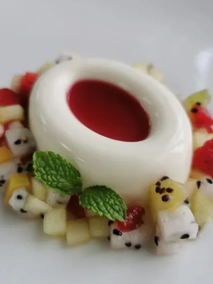 A classic Italian dessert with my own little twist. This is a creamy vanilla panna cotta, filled with a vibrant raspberry coulis and served with a brunoise of fresh, seasonal fruits like dragon fruit and kiwi for a bit of texture and freshness.