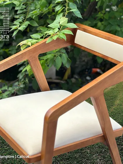 The Zircon chair, crafted from durable teak wood with a luxurious Golden Walnut PU coating. The premium fabric upholstery adds to its elegance and comfort.