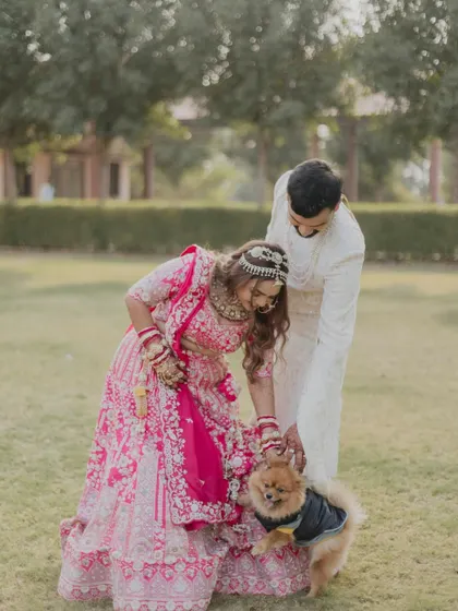 A heartwarming moment as the bride and groom greet their furry family member. We love capturing these personal, candid interactions that show the couple's life and love beyond the ceremony.