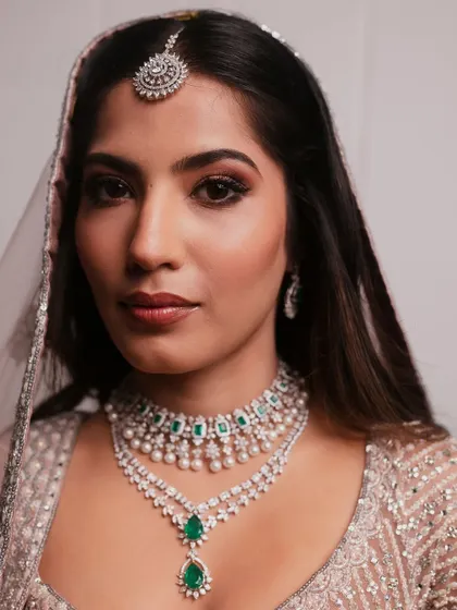 A direct portrait of the modern bride, showing the flawless base and the captivating eye makeup.