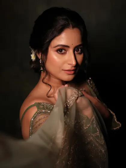 A soft and romantic look for a Diwali-themed shoot. The makeup is warm and glowing, with a delicate floral hair accessory adding a touch of traditional elegance.