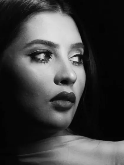 A profile view from the black and white shoot, emphasizing the facial structure through contour and shadow.