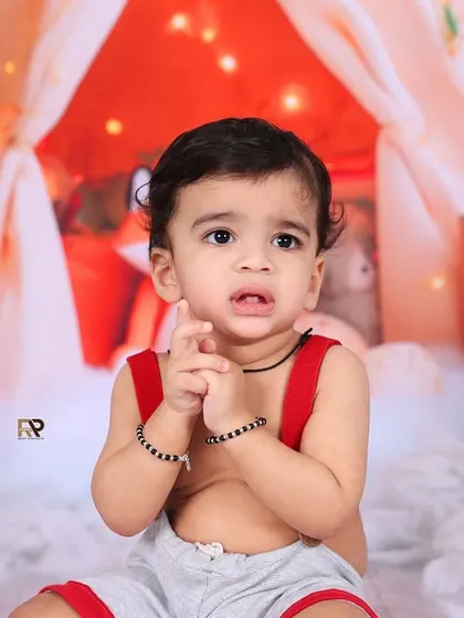 A close-up of a baby's expressive face in a fox-themed woodland setup. The warm, cozy atmosphere and cute props make for an adorable and memorable portrait.