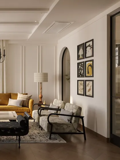 A gallery wall of curated art adds a personal touch to this elegant living area. The arrangement complements the room's classic paneling and arched doorways, showing how we integrate personal stories into a home's design.