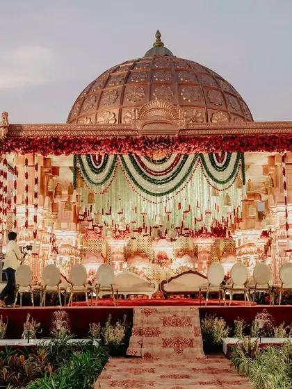 The full view of the monumental temple-style stage, designed to look like a grand palace facade, complete with a domed roof and intricate detailing.