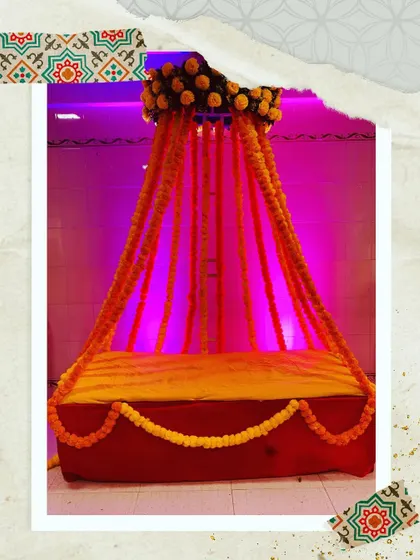 A simple and sweet Haldi or Mehendi seating prop. The marigold flower strings create a traditional and festive feel, perfect for pre-wedding ceremonies.