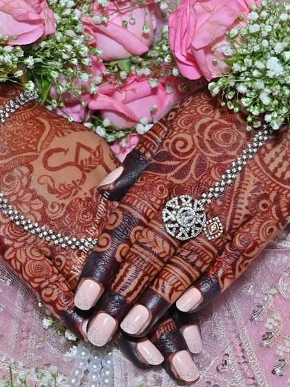 This is the result I live for. A gorgeous, deep henna stain on my bride's hands, perfectly complemented by her floral jewelry. I use only organic henna to ensure you get this rich, beautiful color for your special day.