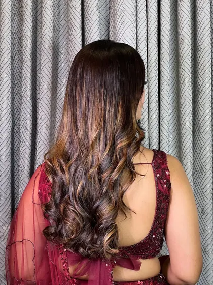 I love creating voluminous, dreamy curls. This hairstyle shows off beautiful caramel highlights and adds a touch of glamour to any look.