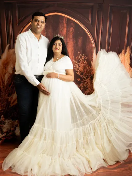 A regal couple's portrait with a stunning white tulle gown. The pose is formal and elegant, perfect for a statement piece.