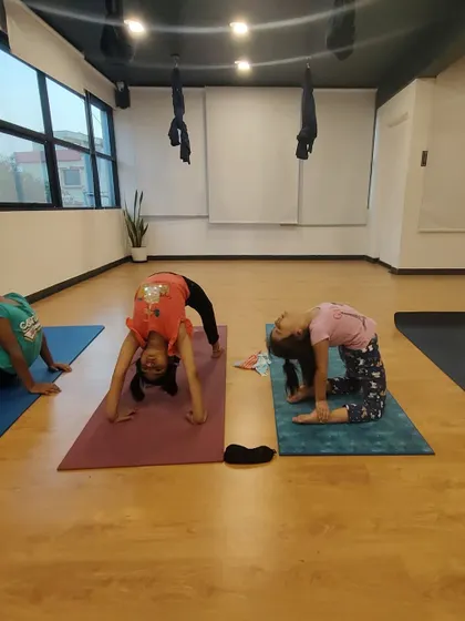 Exploring backbends like Ustrasana (Camel Pose) and Chakrasana (Wheel Pose) in our kids' class. We guide them to safely open their hearts and strengthen their backs.
