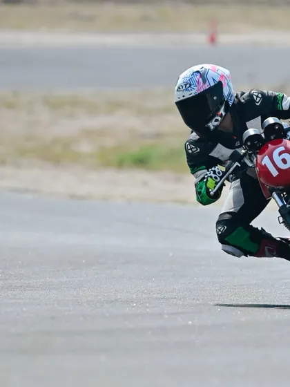 A rider leans into a corner during a track school session, practicing the techniques taught by our coaches.