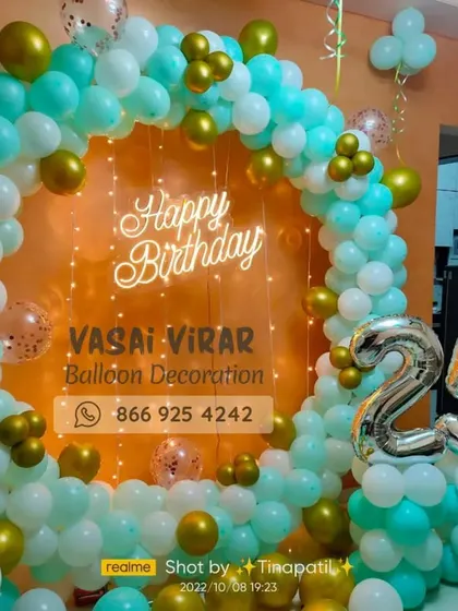 Celebrating a 25th birthday in style. This modern setup features a chic balloon ring in sea green and gold, a custom neon sign, and marquee numbers, perfect for creating a sophisticated and memorable party vibe for adults.