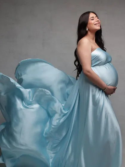 Capturing the beautiful glow of motherhood. For this maternity shoot, we aimed for an angelic and soft look. I used gentle highlighting to accentuate her features and styled her hair in soft, flowing waves to match the ethereal feel of her satin gown.