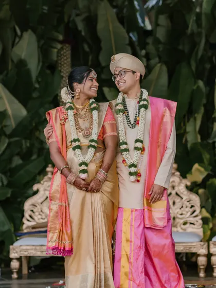 A joyful portrait of the couple, dressed in traditional silk veshti and saree. We love capturing the personalities of our clients, blending solemn rituals with moments of lighthearted fun.