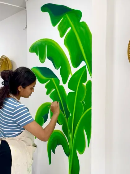 A custom banana leaf mural I painted for a Maharashtrian cuisine restaurant. The vibrant green leaves add a fresh and natural element to the dining space.